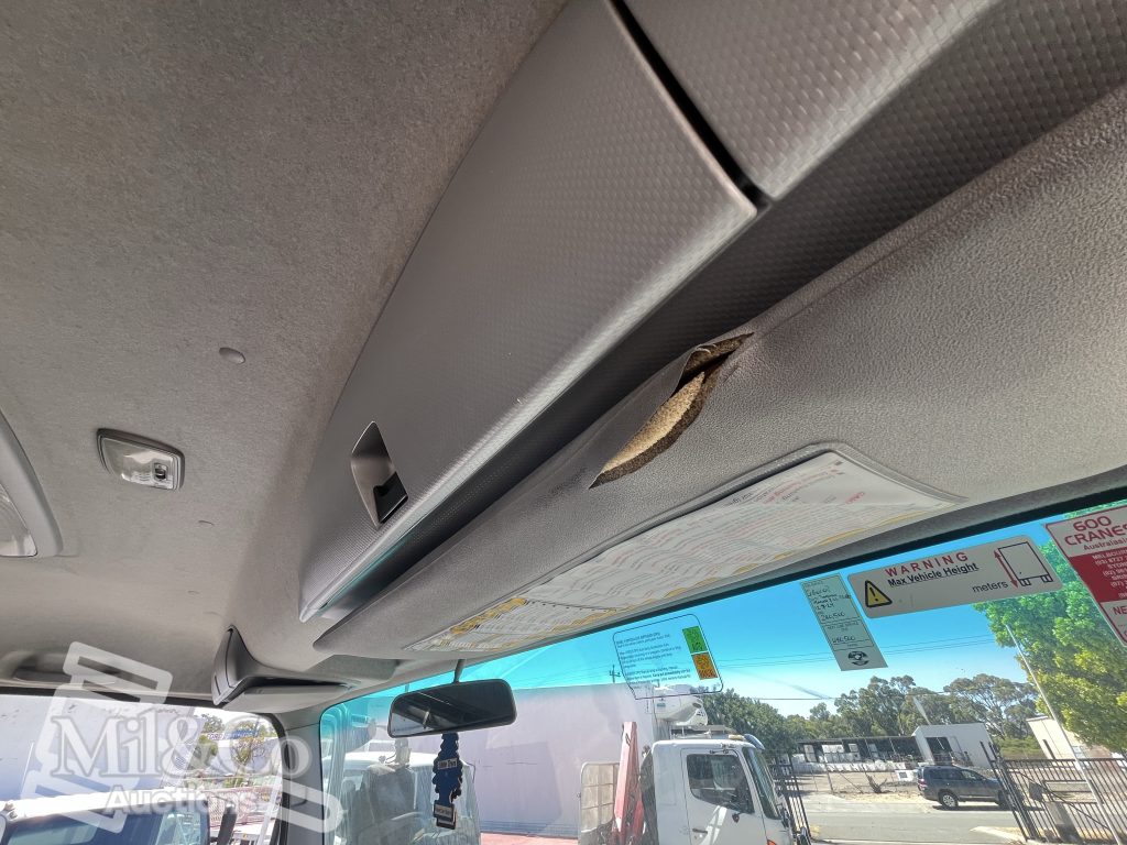 2012 Isuzu FVZ 1000 Tray Back Truck with Hiab interior showing drivers sun visor damage