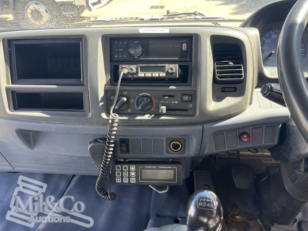 2004 Hino 500 FD Fridge Truck interior dash showing UHF, aftermarket stereo, ThermoKing control panel
