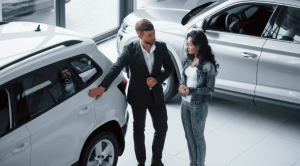 man and woman buying used car at perth auction to save money